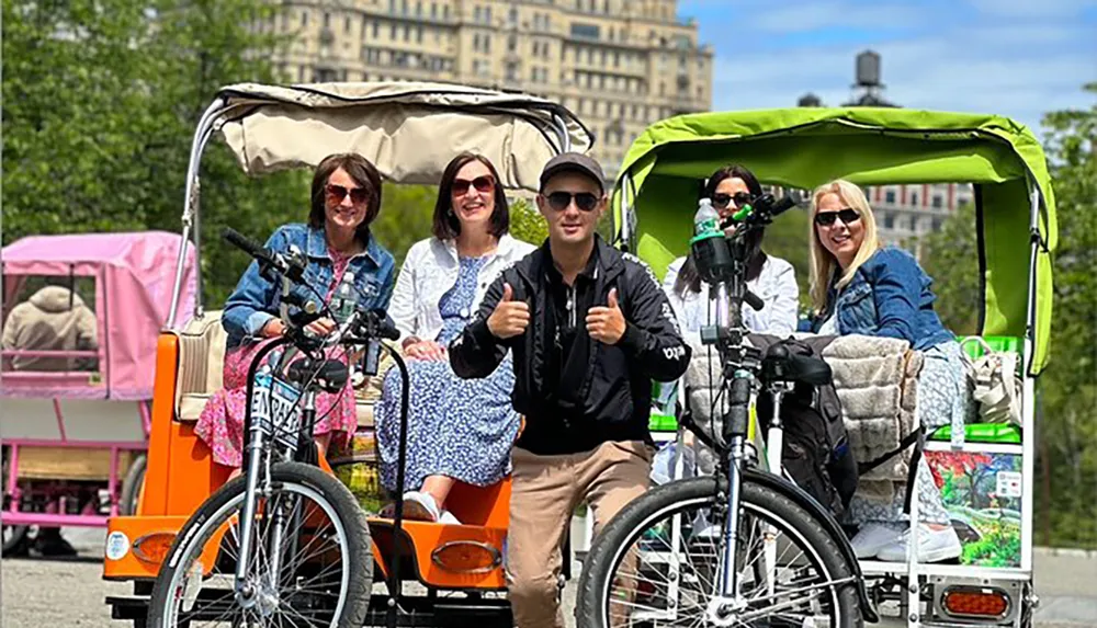 A group of happy tourists is enjoying a ride on pedicabs through a park on a sunny day