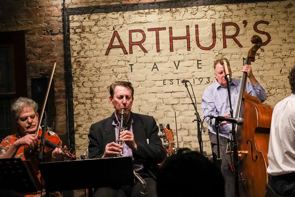A trio of musicians with a violin clarinet and double bass perform live at Arthurs Tavern an establishment established in 1937