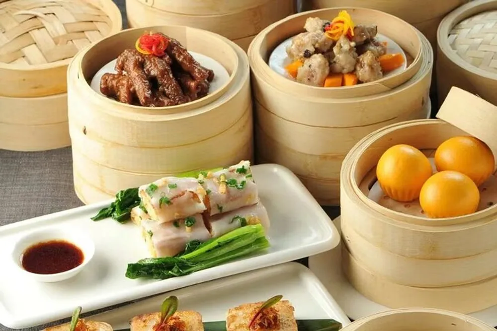 The image features a variety of traditional Chinese dim sum dishes served in bamboo steamers and on ceramic plates