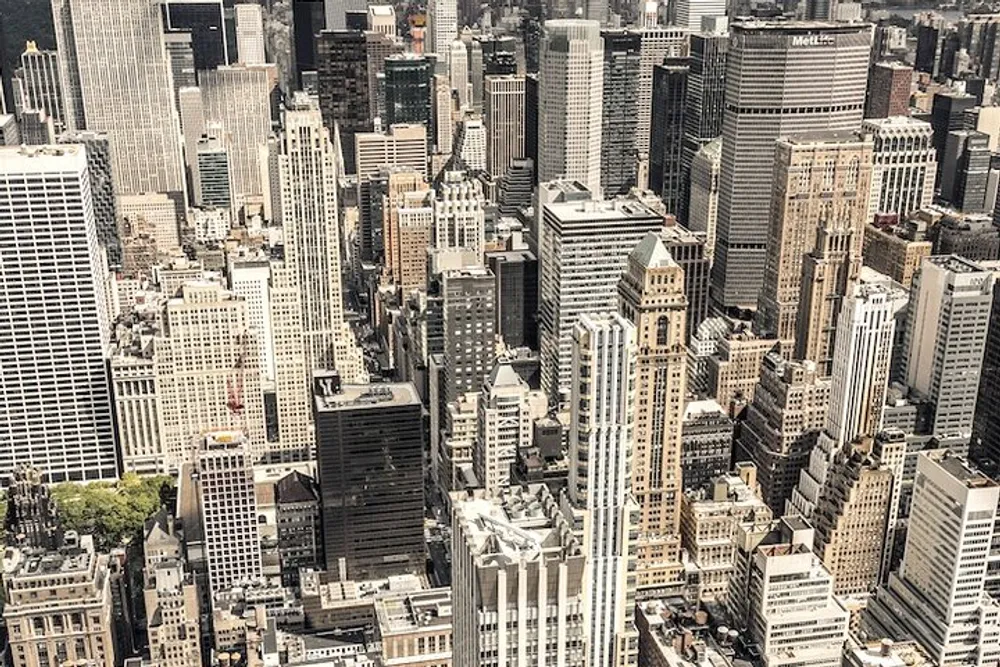 The image shows an aerial view of a dense cityscape with a multitude of skyscrapers and buildings characteristic of a bustling metropolitan area