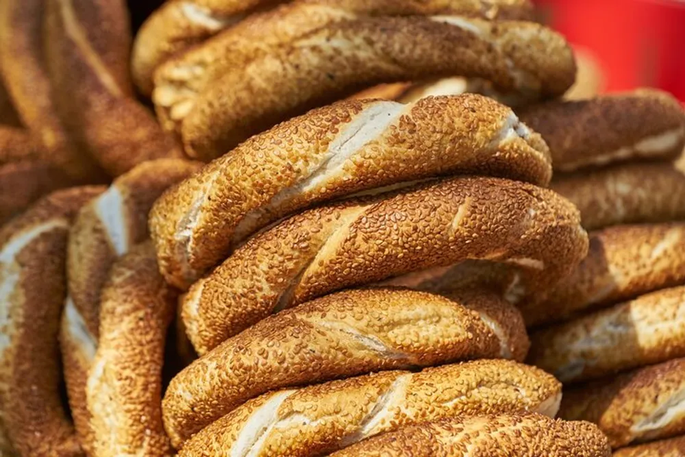 The image shows a stack of sesame-covered bagels called Simit which is a popular street food in Turkey
