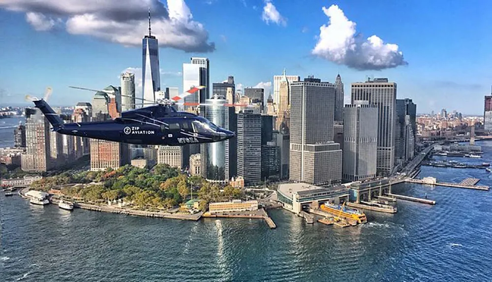 A helicopter is flying over the waterfront of Lower Manhattan with the skyline and the One World Trade Center in the background