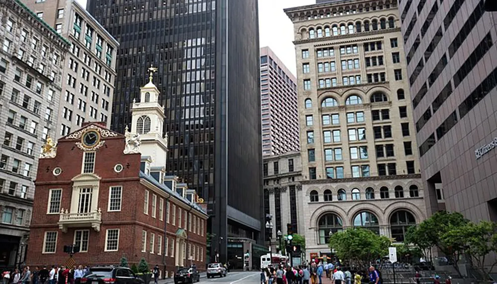 The image shows a mix of historic and modern architecture with people walking in a city street