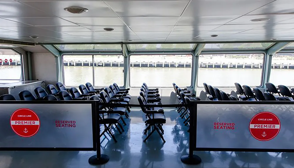 The image shows an interior view of a boat with rows of empty seats and large windows with signage indicating Circle Line Premier Reserved Seating