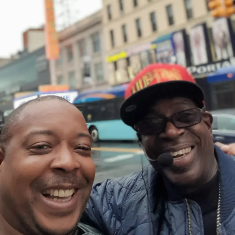 Two happy men are taking a close-up selfie on a city street