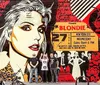 The image shows a colorful urban mural featuring a graphic representation of the iconic lead singer of the band Blondie flanked by concert posters with three individuals posing in front of it