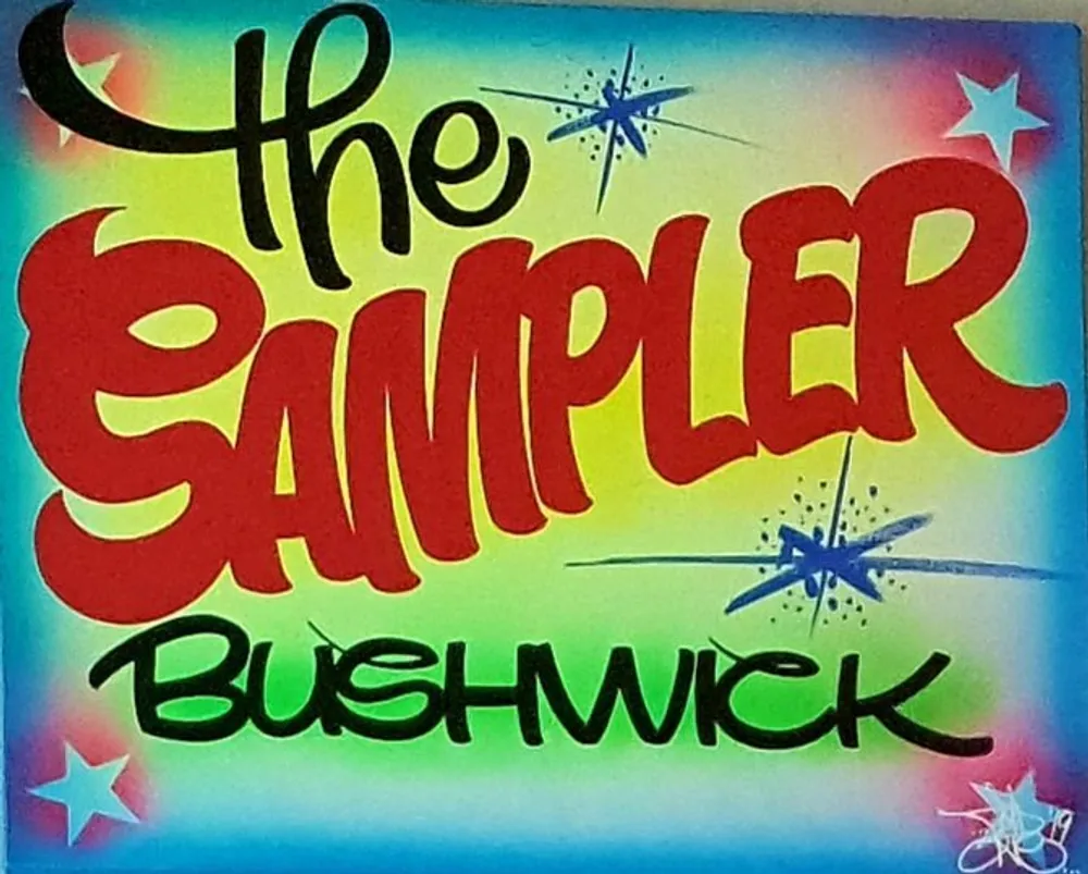 The image showcases a vibrant graffiti-style sign that says The Sampler Bushwick highlighted by stars and an explosion of colors in the background