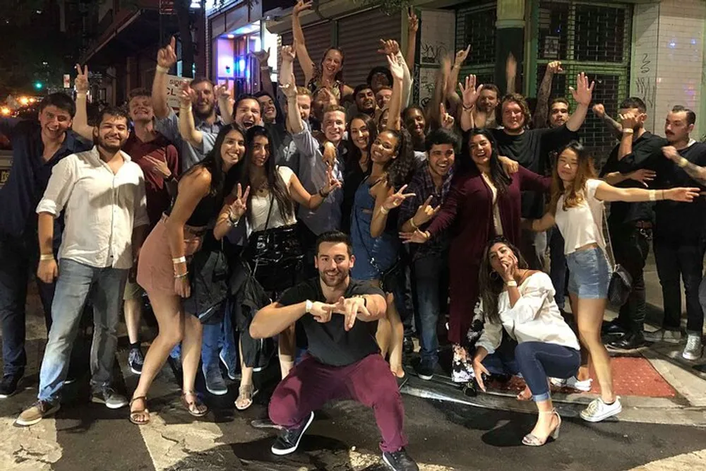 A group of joyful people posing for a group photo on a lively evening out on the town