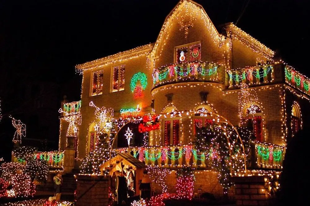 A house is extravagantly adorned with a vibrant display of Christmas lights featuring wreaths garlands and festive decorations covering the entire faade