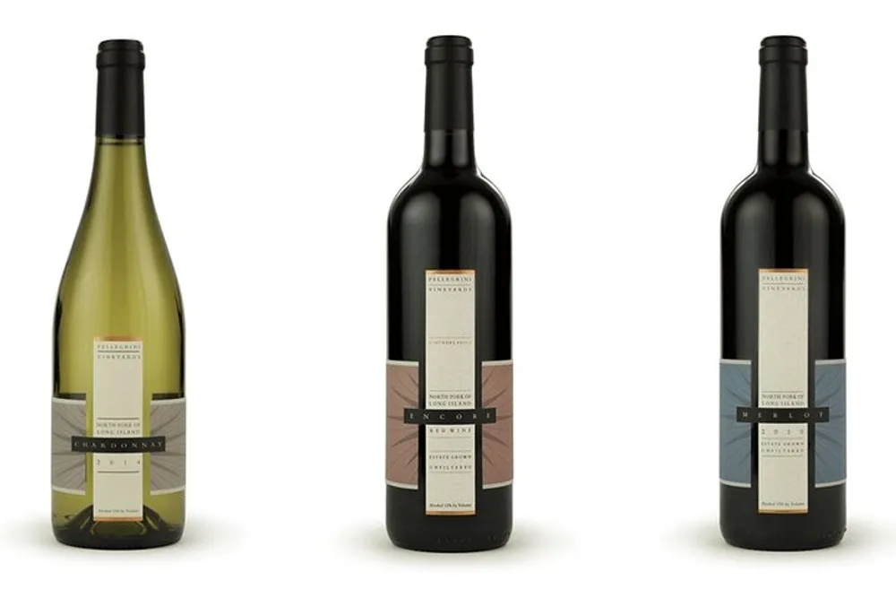 The image shows three wine bottles in a row with the left one appearing to be white wine Chardonnay and the two on the right appearing to be red wines Merlot and Cabernet Sauvignon all with elegant labels and no visible branding