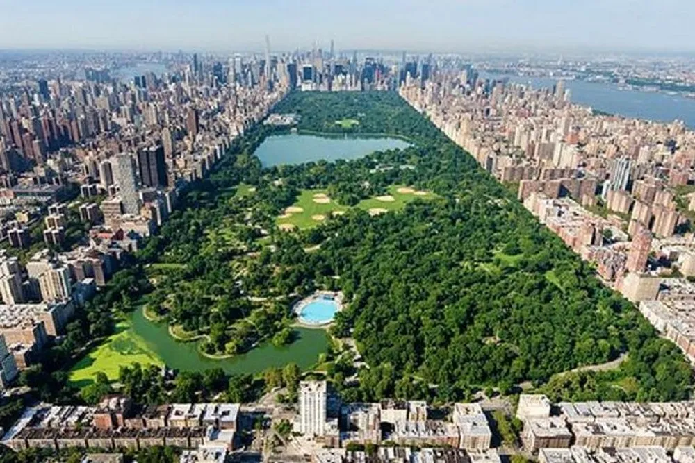 This is an aerial view of Central Park in New York City showcasing its expansive green space amidst the surrounding urban landscape