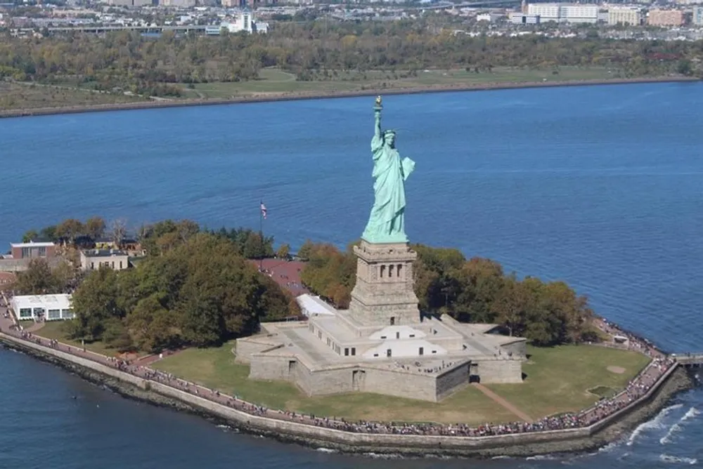 The image shows an aerial view of the Statue of Liberty situated on Liberty Island in New York Harbor