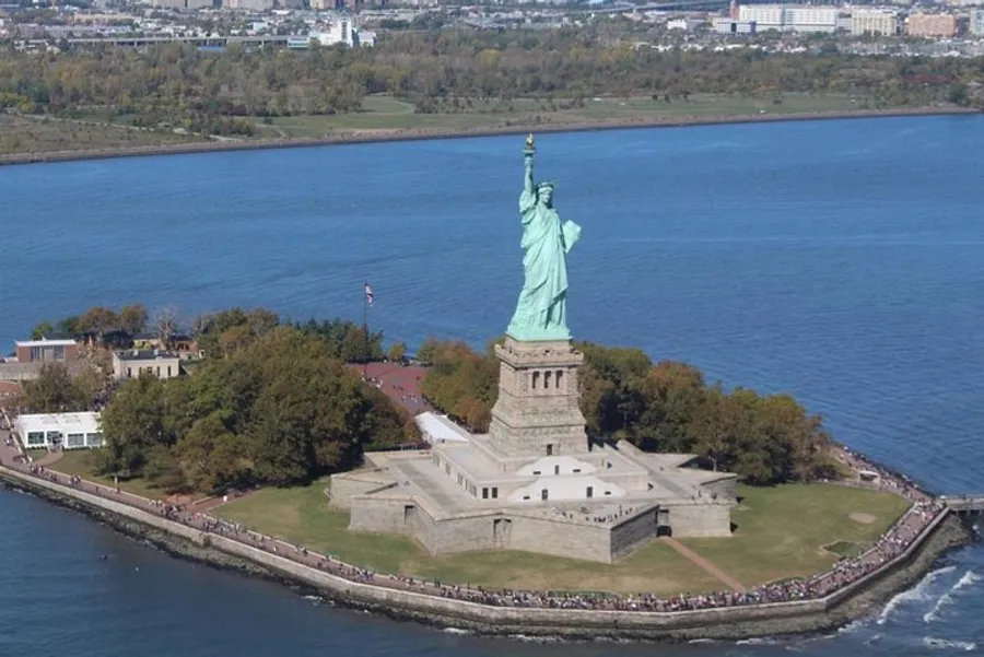 The image shows an aerial view of the Statue of Liberty situated on Liberty Island in New York Harbor.