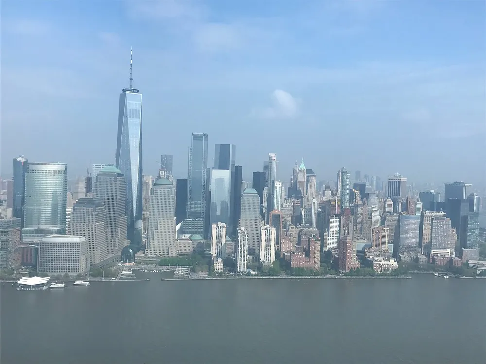 This image features an aerial view of the Manhattan skyline with the One World Trade Center formerly known as the Freedom Tower dominating the scene