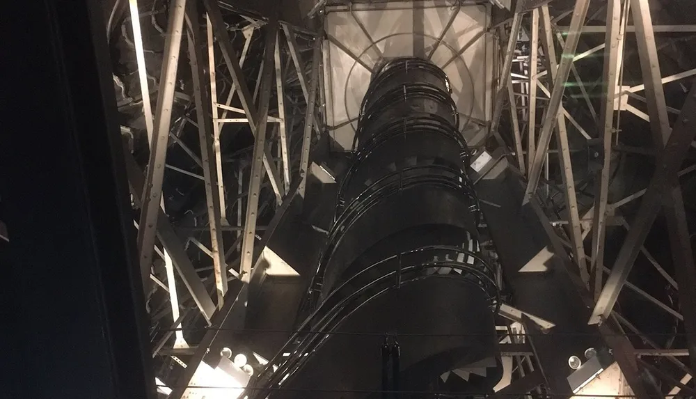 The image showcases a dark interior view of a large complex metal structure possibly the inside of a telescope or industrial machinery