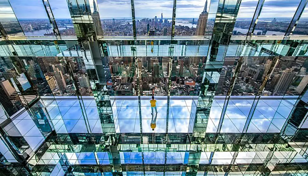 A person stands on a glass floor high above a cityscape offering a dizzying perspective of the urban environment below