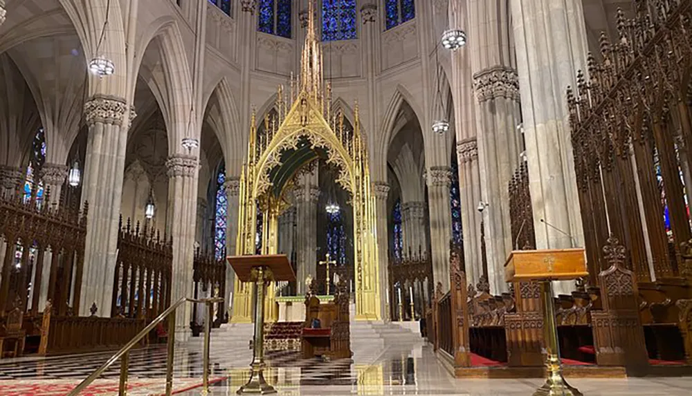 The image shows the interior of a Gothic-style cathedral with an ornate golden altar tall arches and stained glass windows
