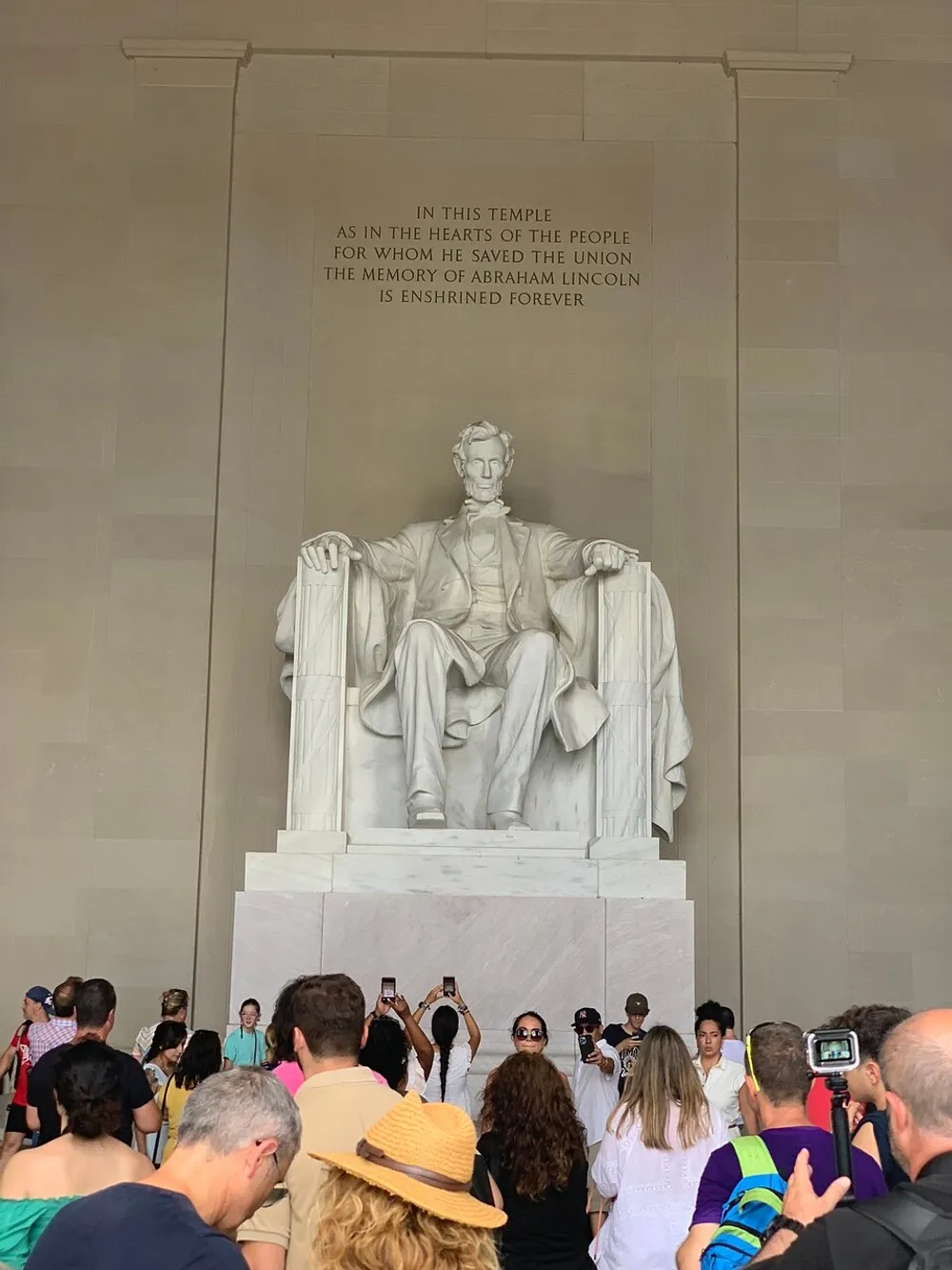 Visitors are gathered to view and take photos of the iconic statue of Abraham Lincoln at the Lincoln Memorial in Washington DC