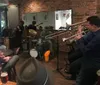 A group of musicians is performing live in a cozy venue with an audience enjoying the atmosphere
