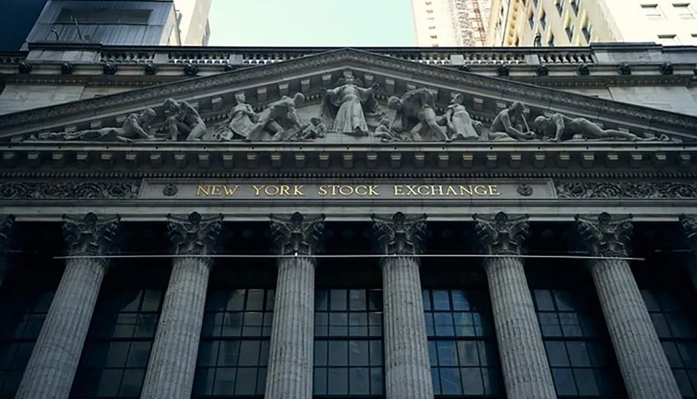 The image showcases the neoclassical facade of the New York Stock Exchange with its columns and distinguished sculpture above the entrance
