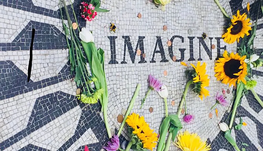 The image shows a mosaic with the word IMAGINE surrounded by an assortment of colorful flowers and scattered petals