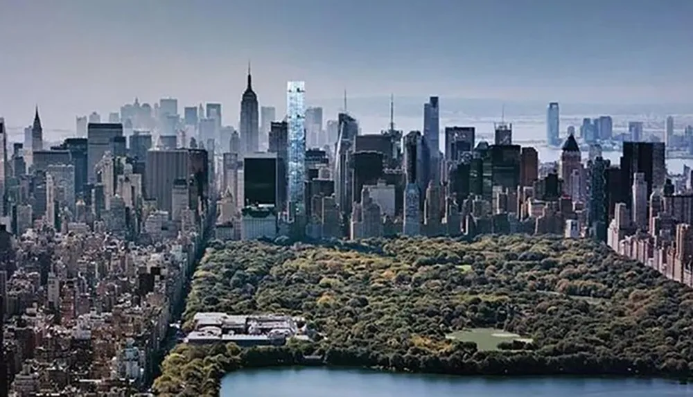 This image showcases a panoramic view of a dense urban skyline with a large park in the foreground likely Central Park in New York City contrasting nature with the built environment